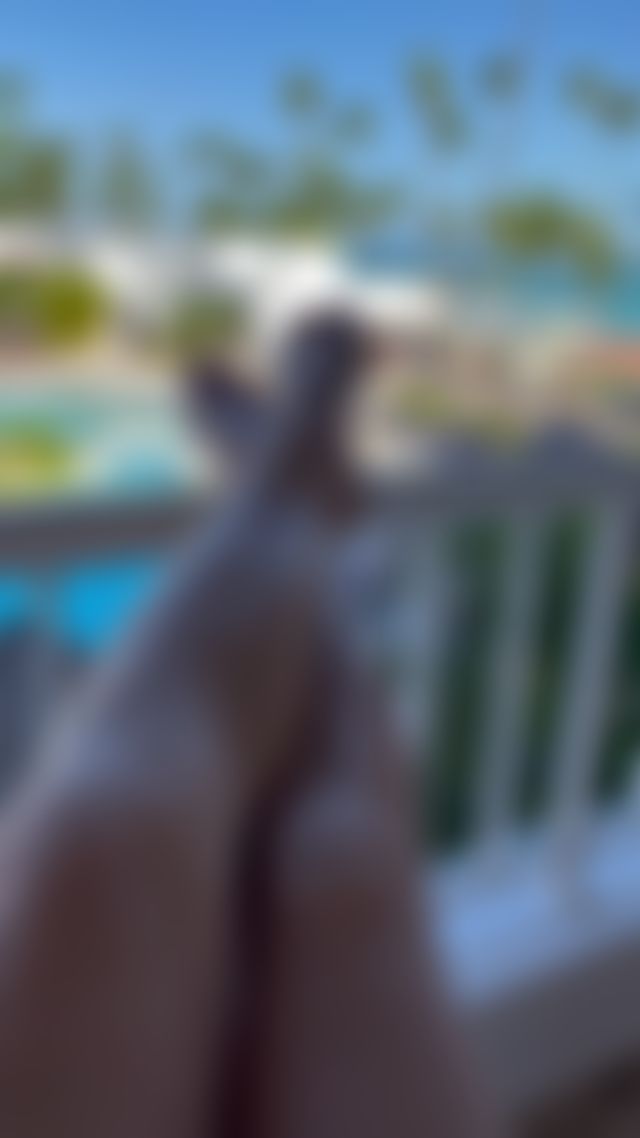 Sandy and salty toes relaxing with a poolside view. Follow for wellness luxury sole conten