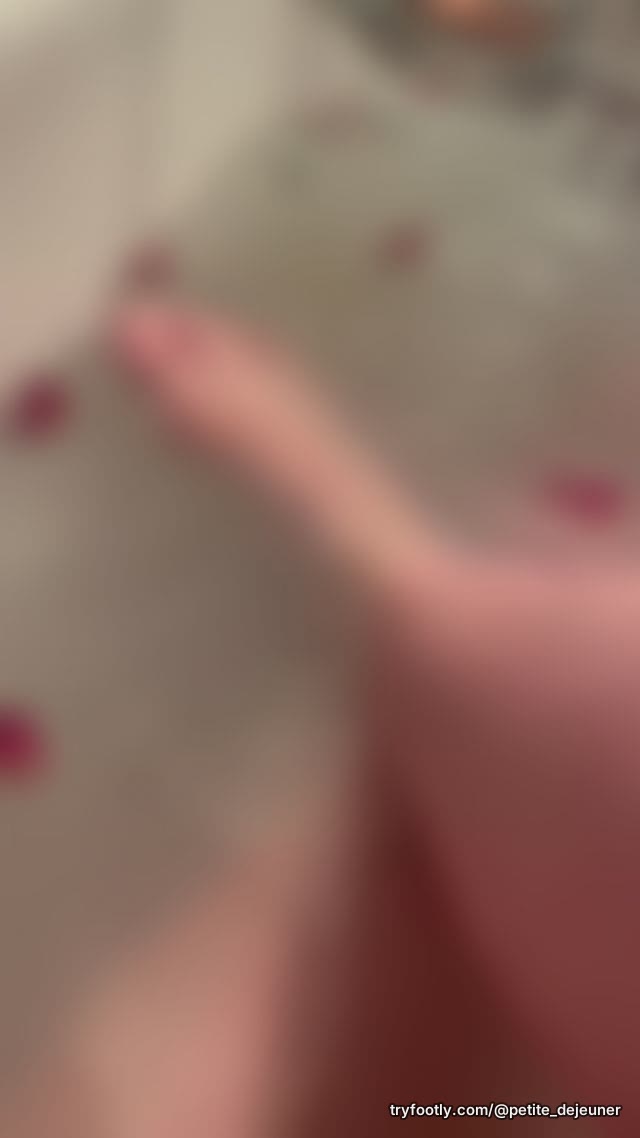 Taking a bath and listening to a naughty book. Rose petals and bath salts a must. Toes are