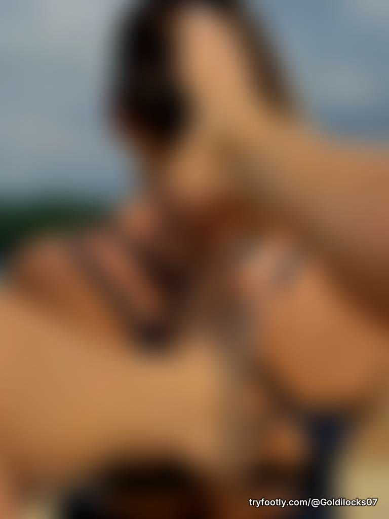 My feet on my girlfriends back, white toes enjoying the sun and the lake. How bout u come 