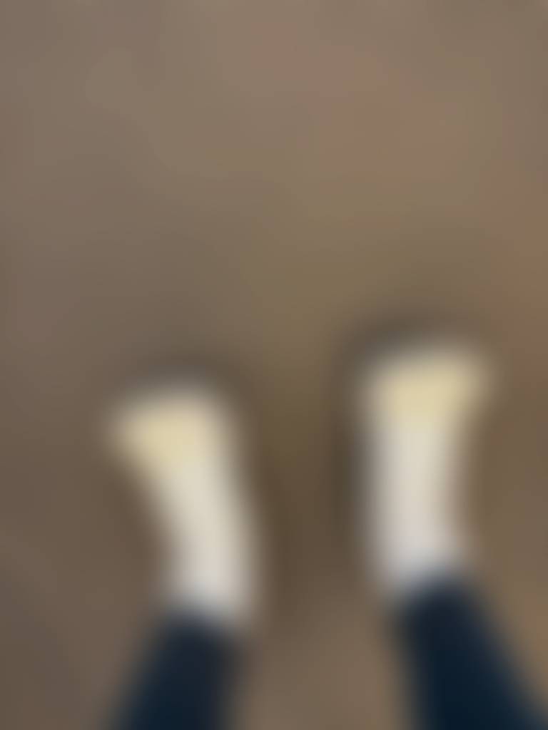 “A candid shot of sock-clad feet during a workout, capturing the moment of effort and move