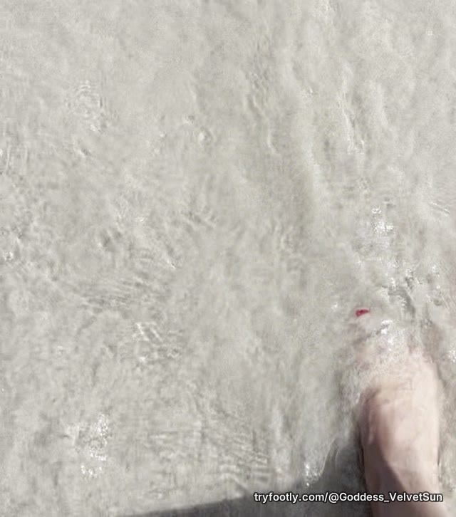 My feet with red nails are walking into the ocean. You follow me? It's getting wet 💦