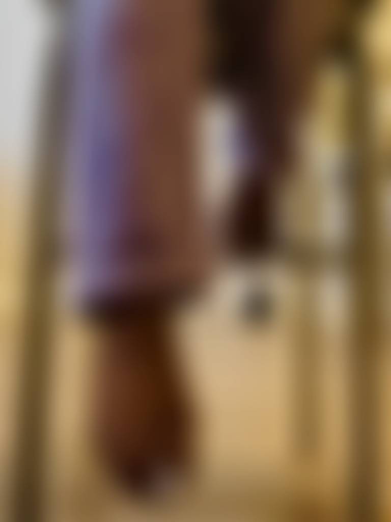 Barefoot poses in purple smiley fleece pants