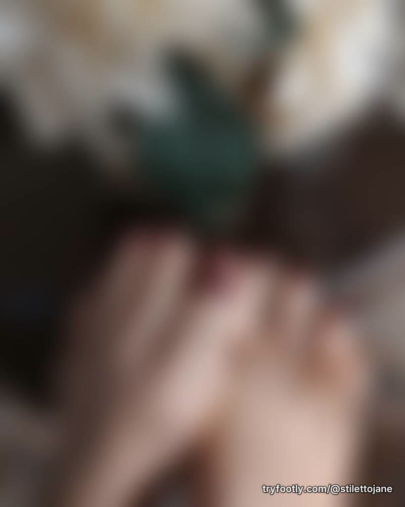 💐Beautiful Tease: polished long toes on wooden coffee table with flowers. Closeup of skin 