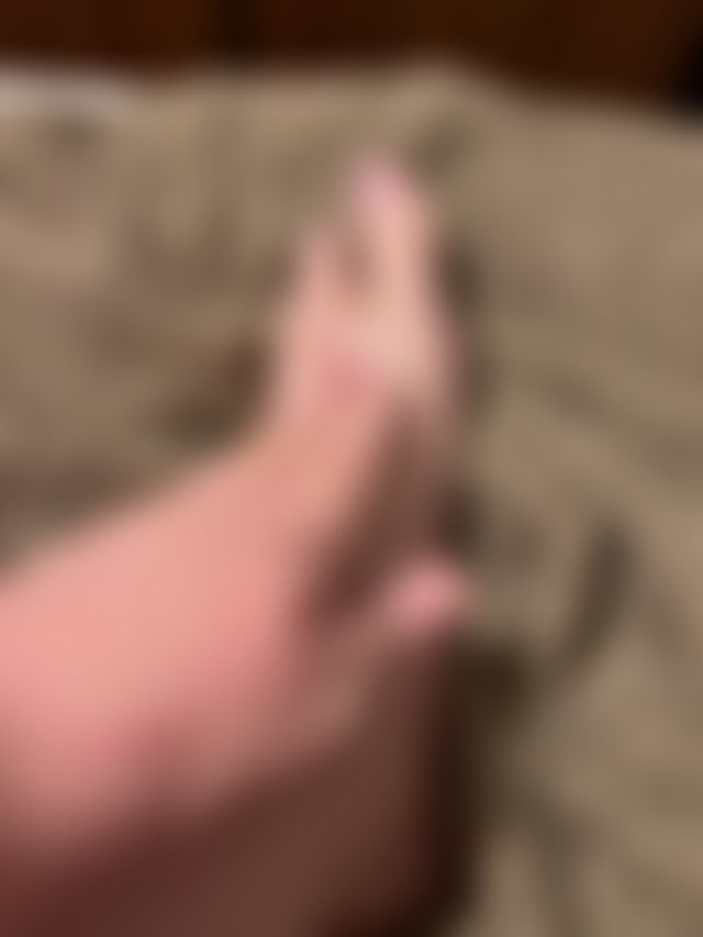 Rubbing lotion on my tired toes.